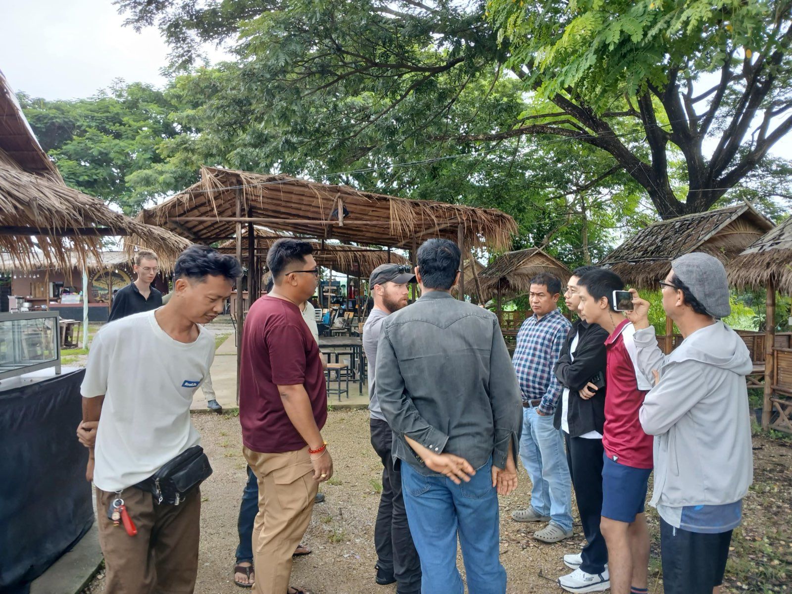 Participants standing in a circle during an outdoor session on photography fundamentals