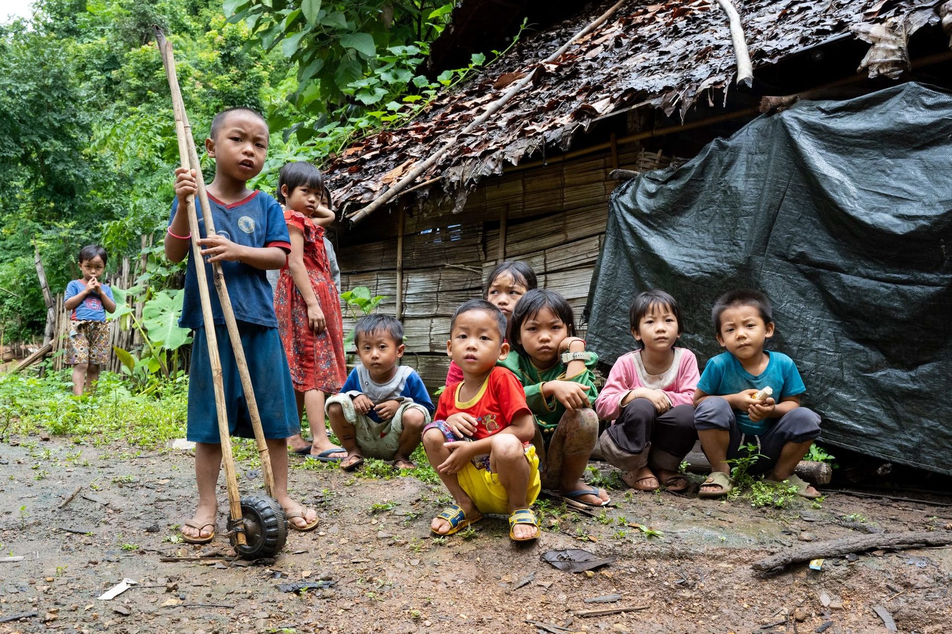 Children gathered outside a shelter in Burma, 2025